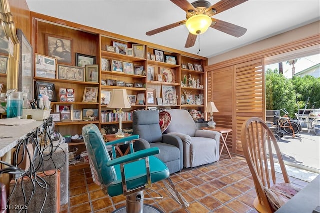 living area with ceiling fan and tile patterned floors