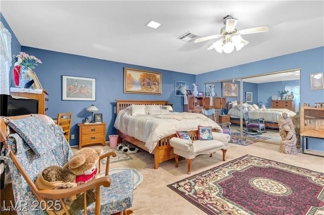 bedroom featuring light colored carpet and ceiling fan