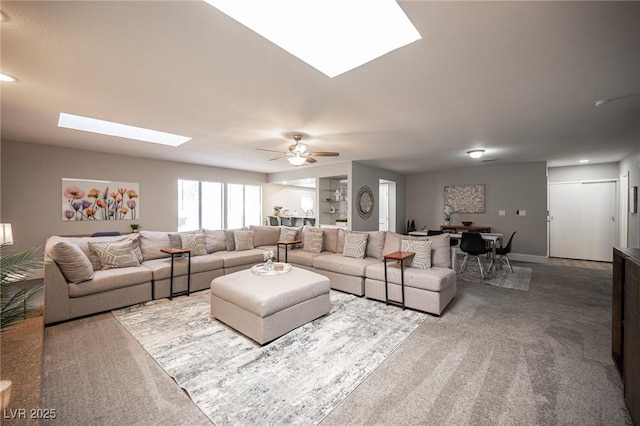 carpeted living room featuring ceiling fan