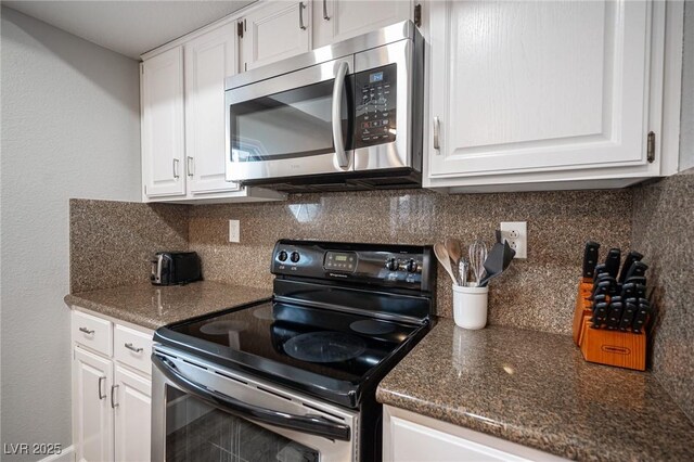 kitchen with stainless steel appliances, tasteful backsplash, and white cabinetry