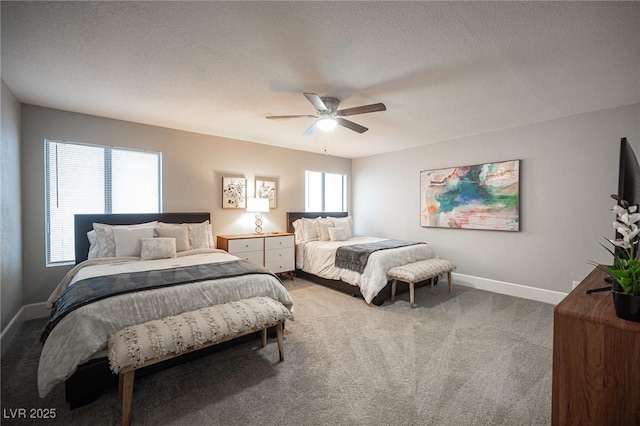 bedroom with light colored carpet, ceiling fan, and a textured ceiling