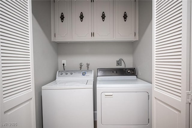 washroom featuring washer and dryer and cabinets