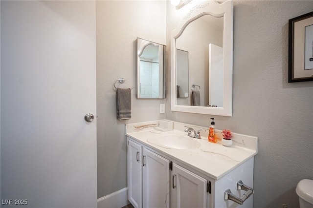 bathroom featuring toilet and vanity