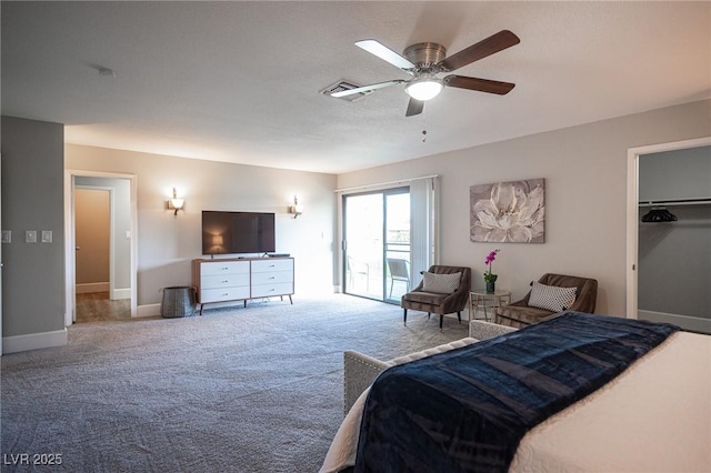 carpeted bedroom featuring ceiling fan, a spacious closet, and a closet