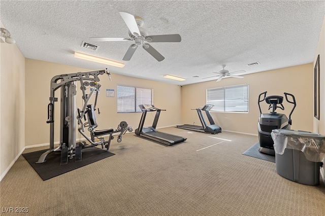 exercise room featuring a textured ceiling, carpet floors, and ceiling fan