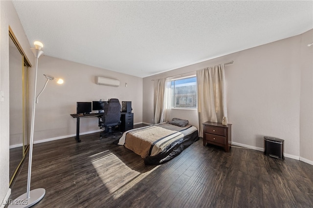 bedroom featuring an AC wall unit, a closet, a textured ceiling, and dark wood-type flooring