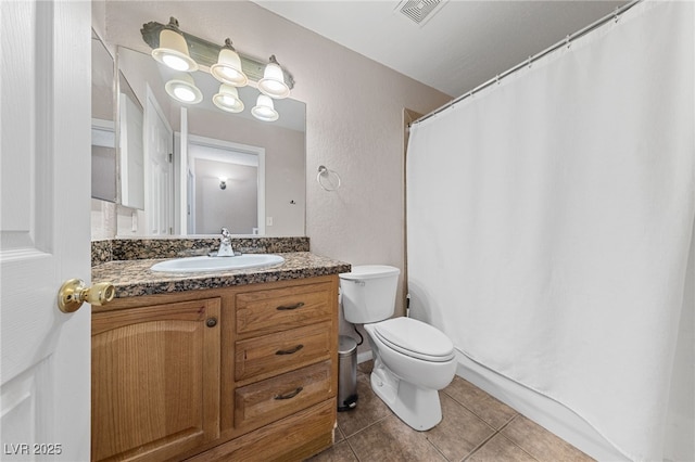 bathroom featuring toilet, vanity, and tile patterned floors