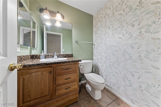 bathroom featuring tile patterned floors, vanity, and toilet