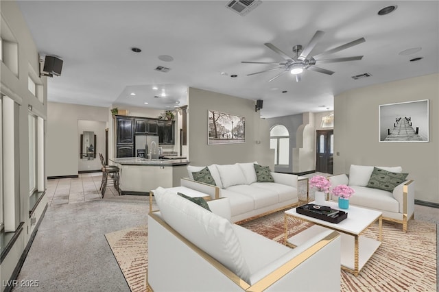 living room featuring light colored carpet and ceiling fan