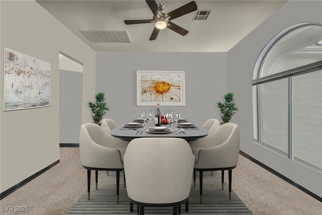 carpeted dining room featuring ceiling fan