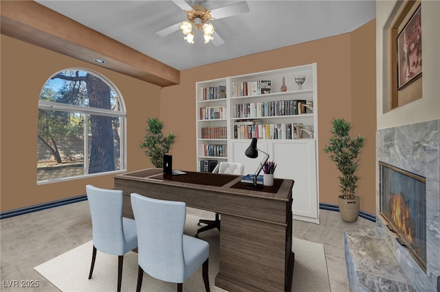 home office with built in features and ceiling fan