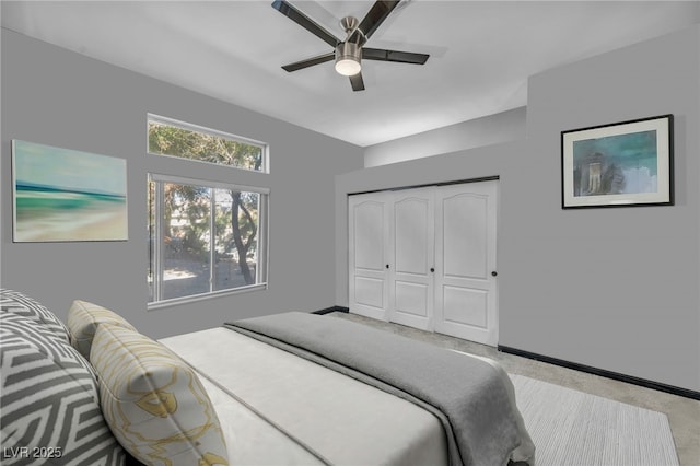 carpeted bedroom featuring ceiling fan and a closet