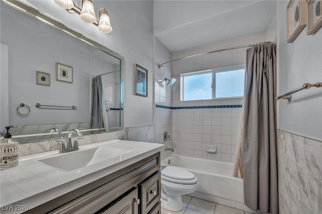 full bathroom with toilet, tile patterned flooring, shower / tub combo with curtain, tile walls, and vanity