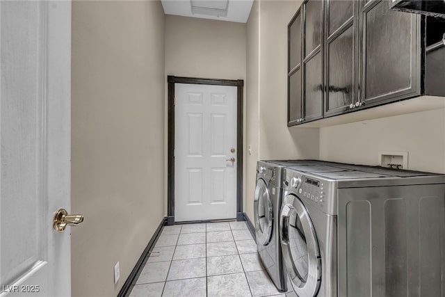 laundry room with cabinets, independent washer and dryer, and light tile patterned floors