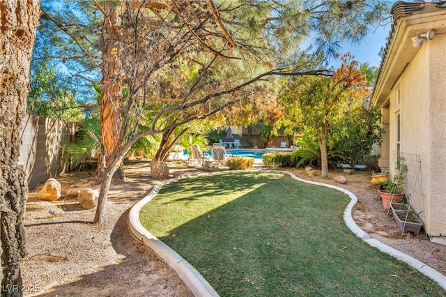 view of yard with a fenced in pool