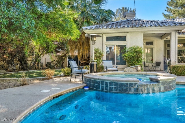 view of swimming pool with an in ground hot tub