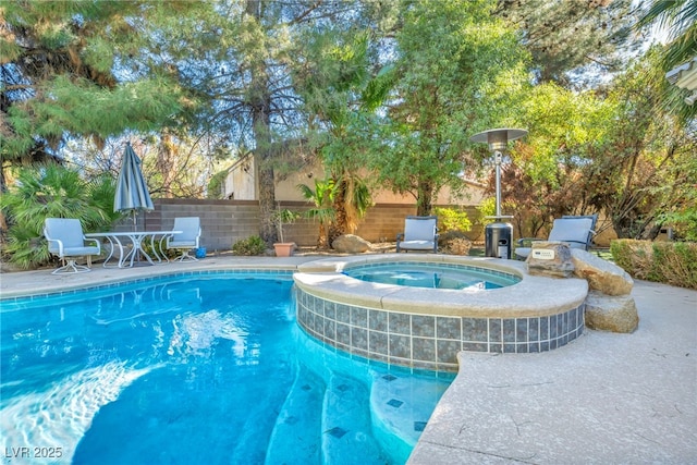 view of pool featuring an in ground hot tub