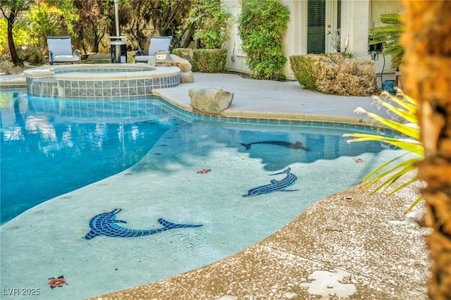 view of swimming pool with an in ground hot tub