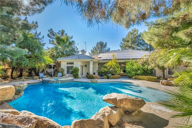 view of pool featuring an in ground hot tub