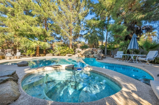 view of swimming pool with a patio and an in ground hot tub