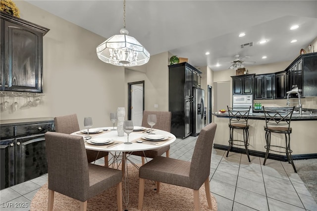 tiled dining area featuring ceiling fan