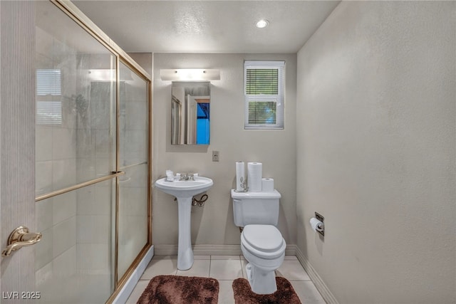 bathroom featuring an enclosed shower, tile patterned floors, and toilet