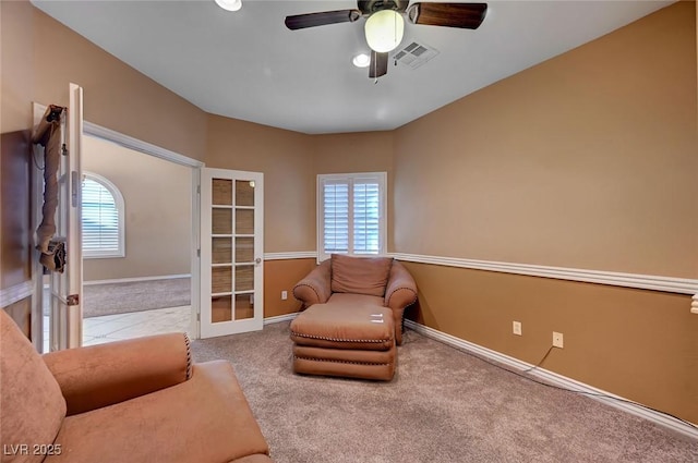 sitting room with french doors, carpet flooring, ceiling fan, and a wealth of natural light