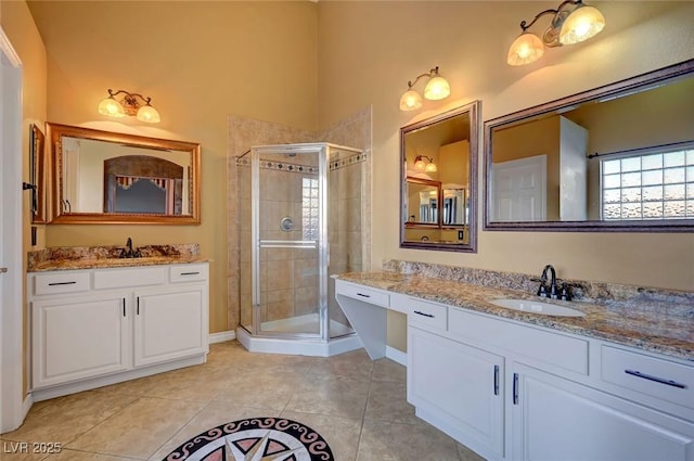 bathroom featuring vanity, walk in shower, and tile patterned flooring