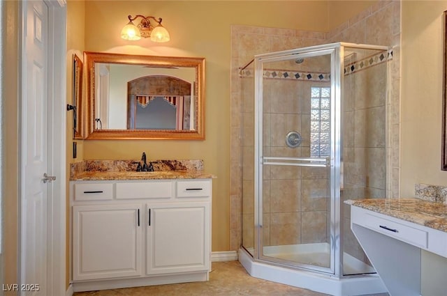 bathroom featuring tile patterned flooring, a shower with door, and vanity