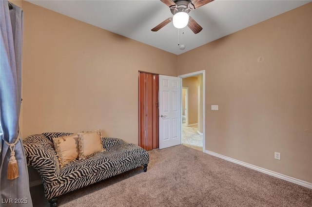 sitting room with ceiling fan and carpet