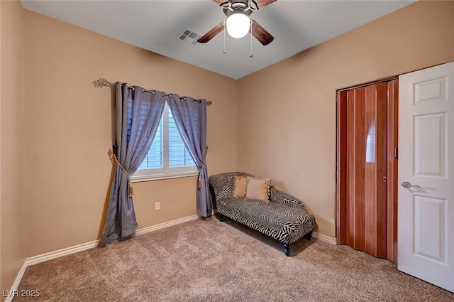 sitting room featuring ceiling fan and light colored carpet