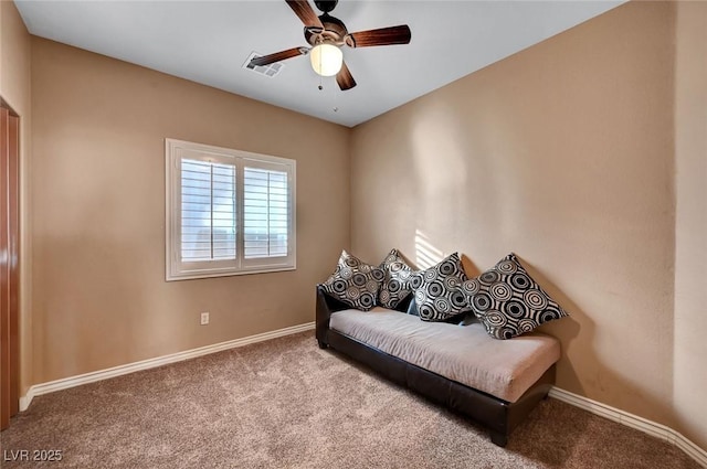 sitting room with ceiling fan and carpet flooring