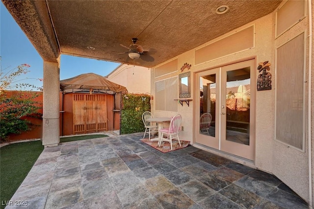 view of patio / terrace with a gazebo, french doors, and ceiling fan