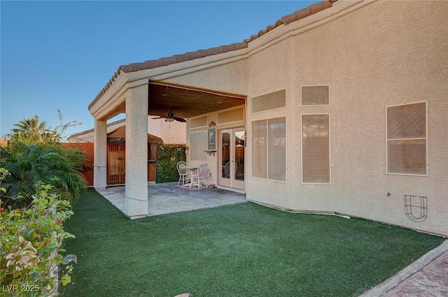 back of house featuring a lawn, french doors, a patio area, and ceiling fan