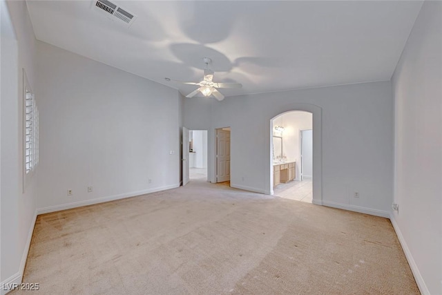 empty room featuring ceiling fan and light colored carpet