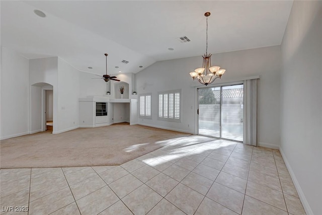 unfurnished living room featuring vaulted ceiling, ceiling fan with notable chandelier, and light tile patterned floors