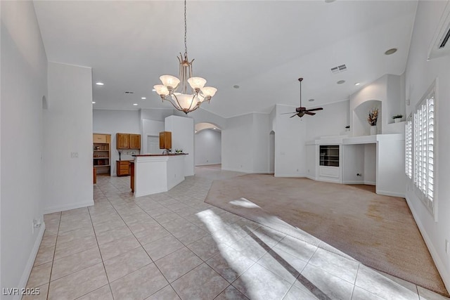 unfurnished living room with ceiling fan with notable chandelier and light carpet