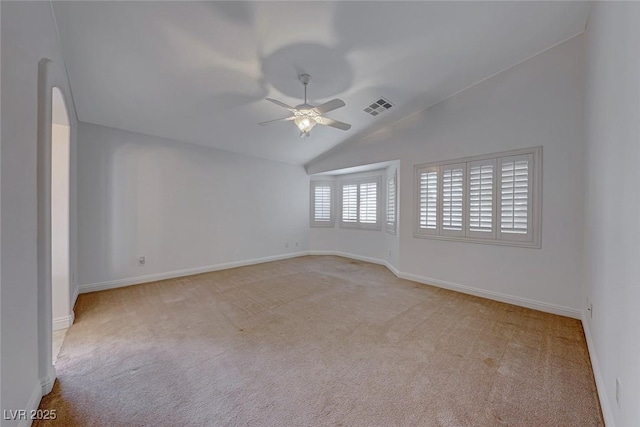 carpeted empty room featuring ceiling fan and vaulted ceiling