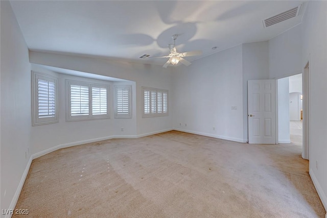 unfurnished room with lofted ceiling, light colored carpet, and ceiling fan