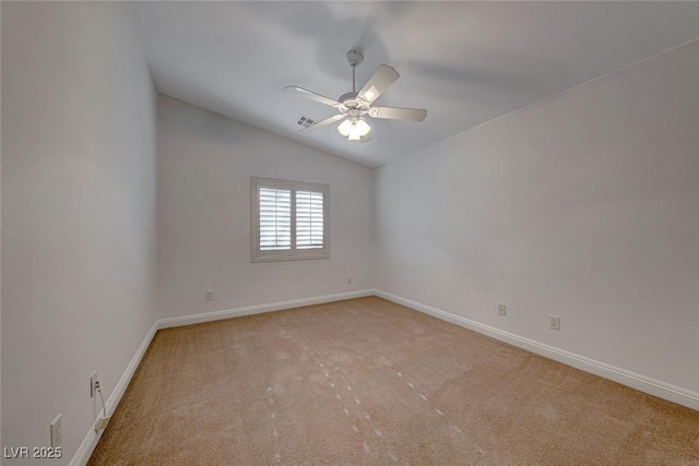 carpeted spare room featuring ceiling fan and vaulted ceiling