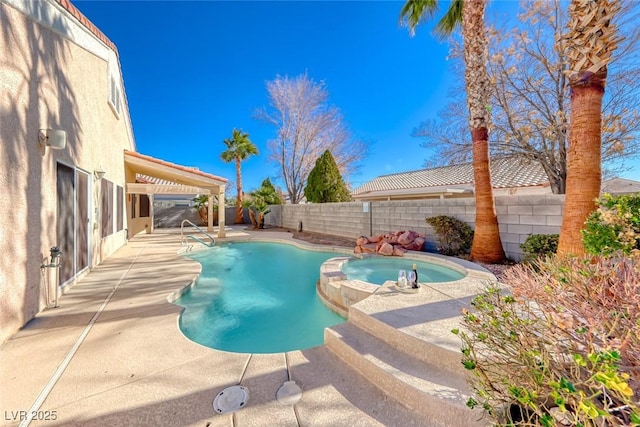 view of swimming pool featuring a patio area and an in ground hot tub