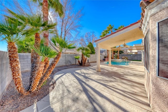 view of patio / terrace with ceiling fan and a fenced in pool