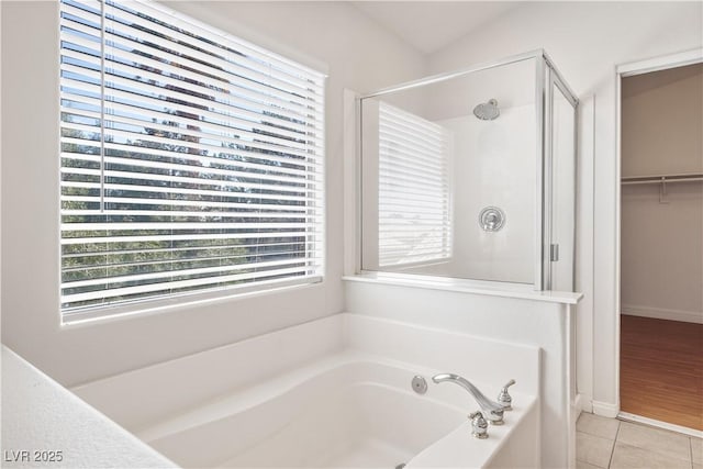 bathroom featuring vaulted ceiling, tile patterned floors, and independent shower and bath