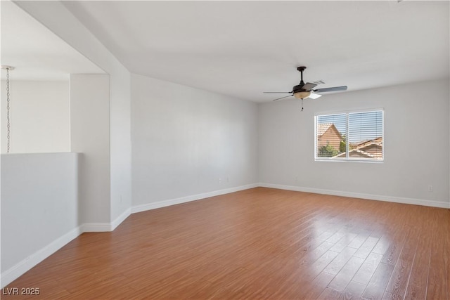 unfurnished room with ceiling fan and hardwood / wood-style flooring