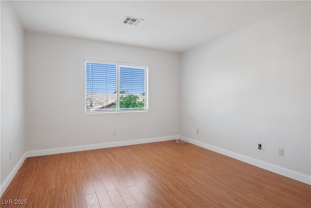 spare room with hardwood / wood-style flooring