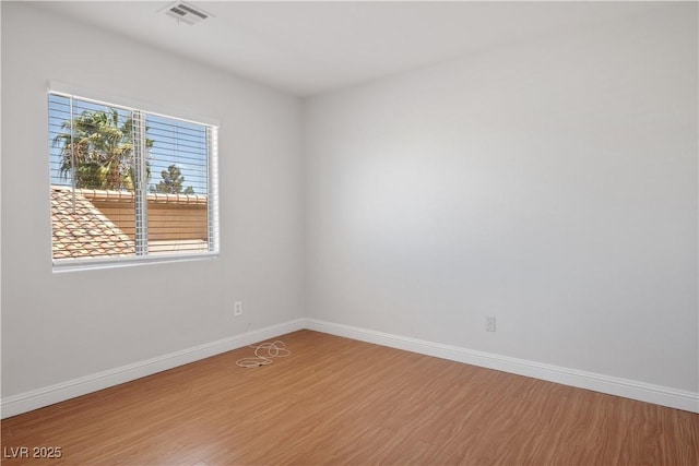 unfurnished room featuring wood-type flooring and a healthy amount of sunlight