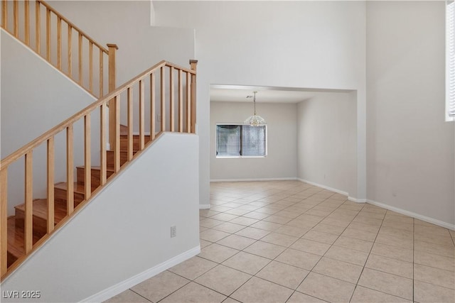 staircase with tile patterned flooring and a chandelier