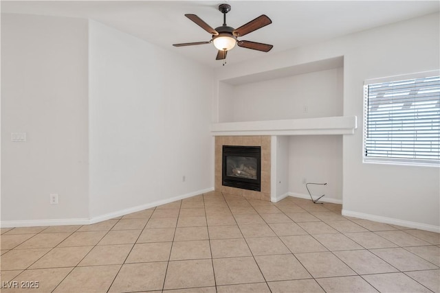 unfurnished living room with a fireplace, ceiling fan, and light tile patterned floors