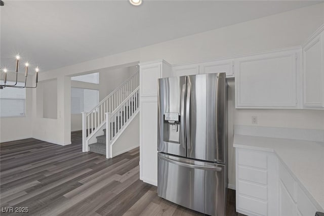 kitchen featuring white cabinets, a notable chandelier, stainless steel fridge, and dark hardwood / wood-style floors