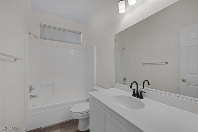 full bathroom featuring toilet, vanity, hardwood / wood-style flooring, and tub / shower combination